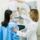 mamografia digital: mulher realizando mamografia digital com ajuda de doutora